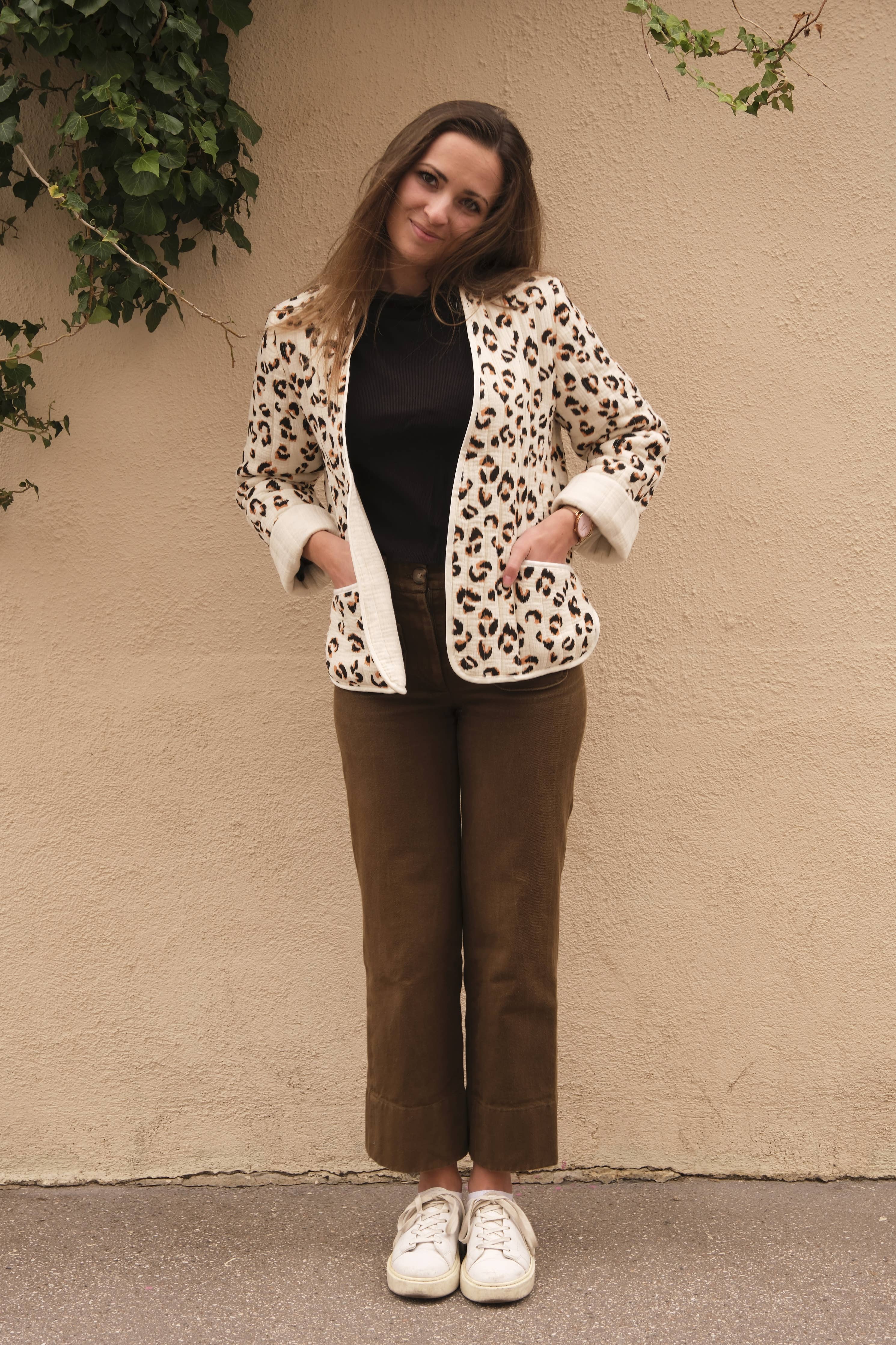 Front view of the leopard quilted Siloé Jacket with white sneakers