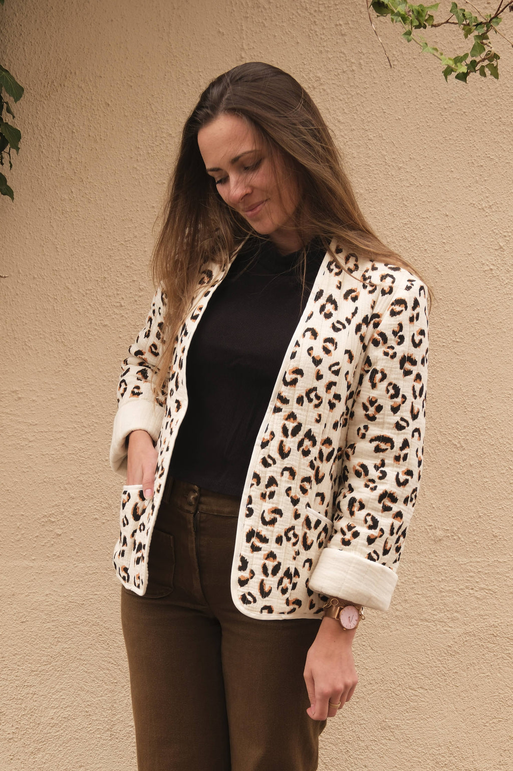 Siloé Jacket sewing pattern by Cha' coud sewn in leopard-print quilted fabric, worn open with brown trousers