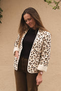 Siloé Jacket sewing pattern by Cha' coud sewn in leopard-print quilted fabric, worn open with brown trousers