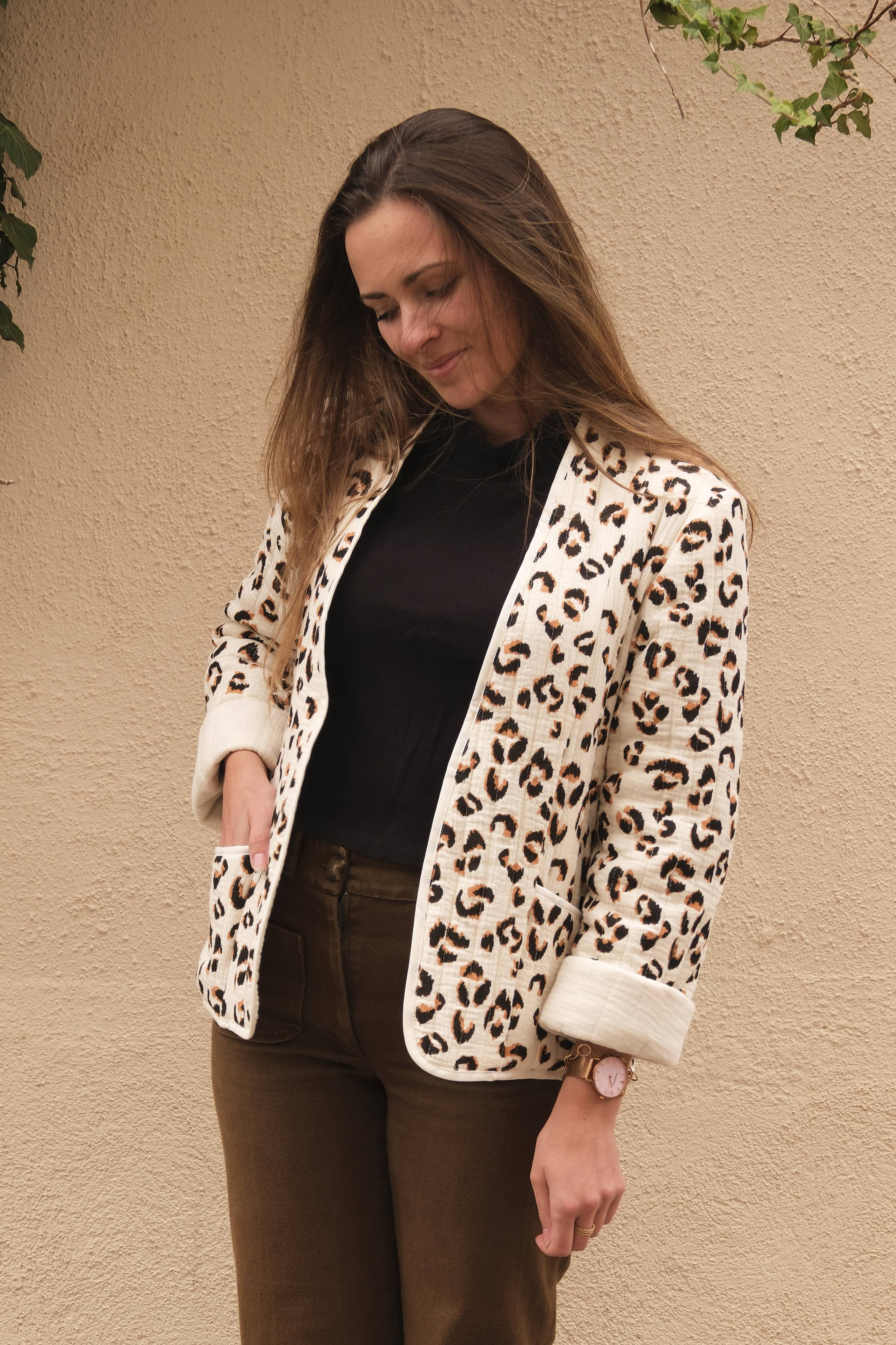 Siloé Jacket sewing pattern by Cha' coud sewn in leopard-print quilted fabric, worn open with brown trousers