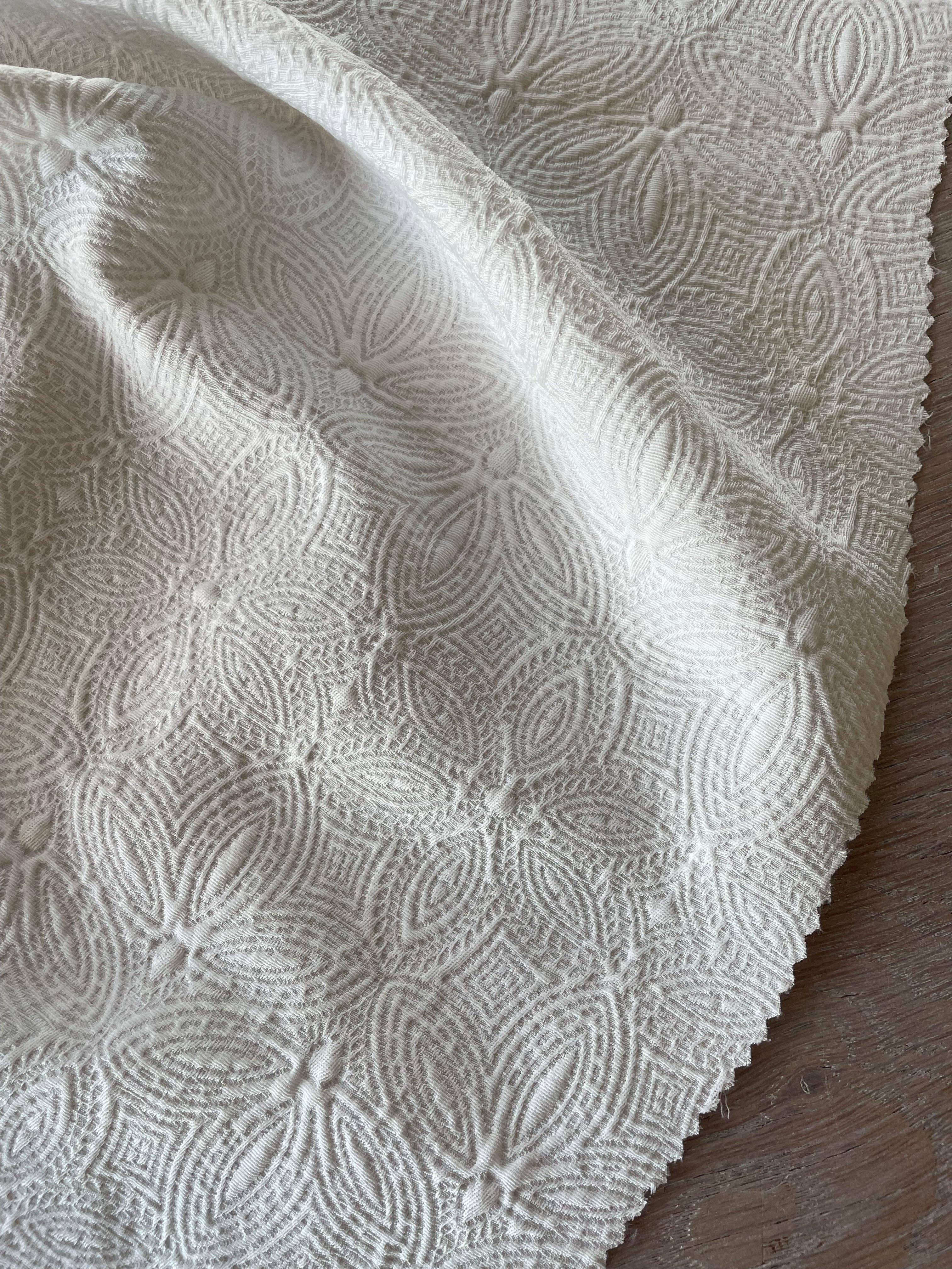 Close-up of Poem jacquard fabric by Atelier 27 showing delicate ivory woven floral texture