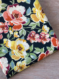 Atelier 27 Pia print fine cotton poplin fabric, ochre red and green floral on black