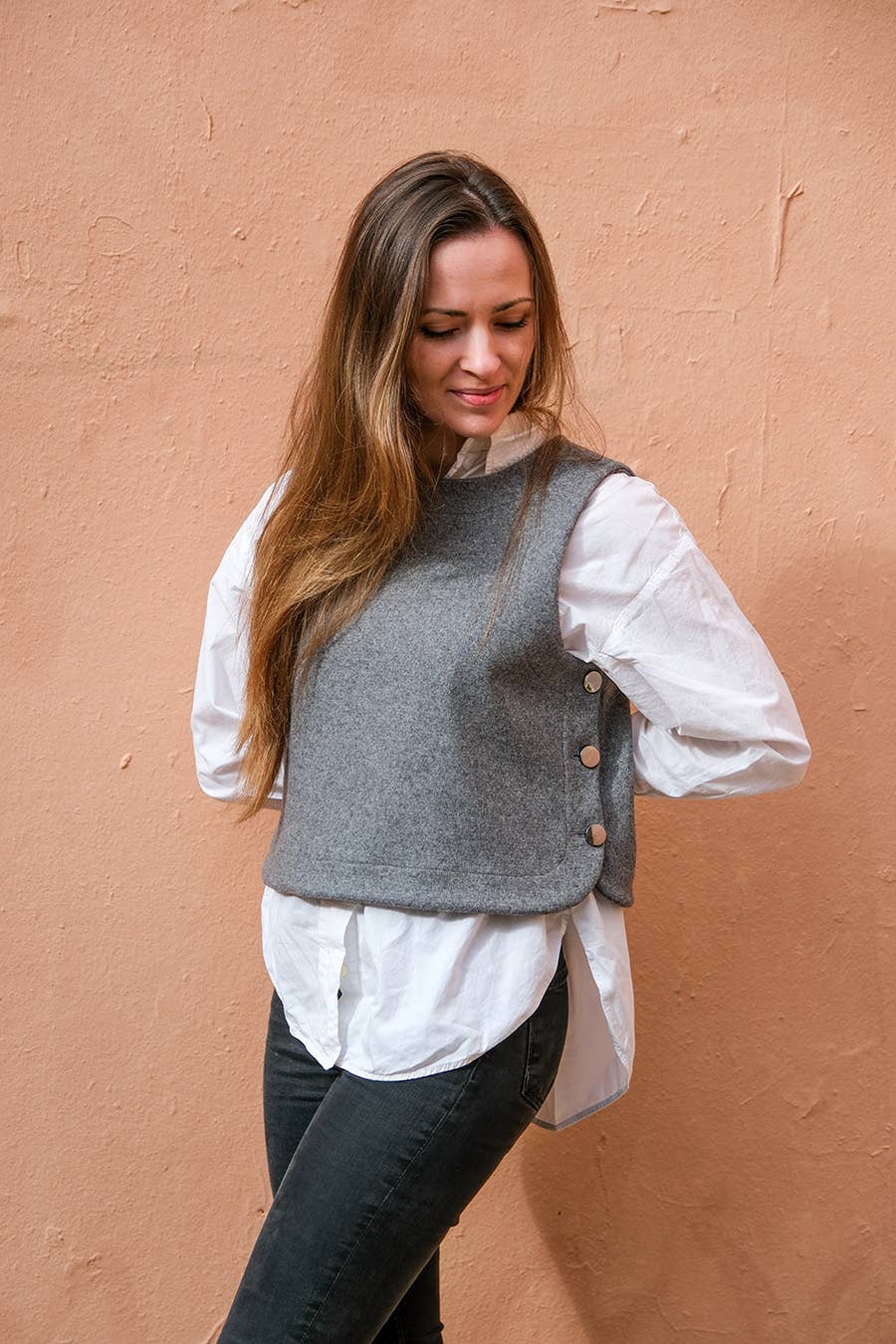 Grey Téva Slipover worn open-collared over a white shirt, relaxed pose