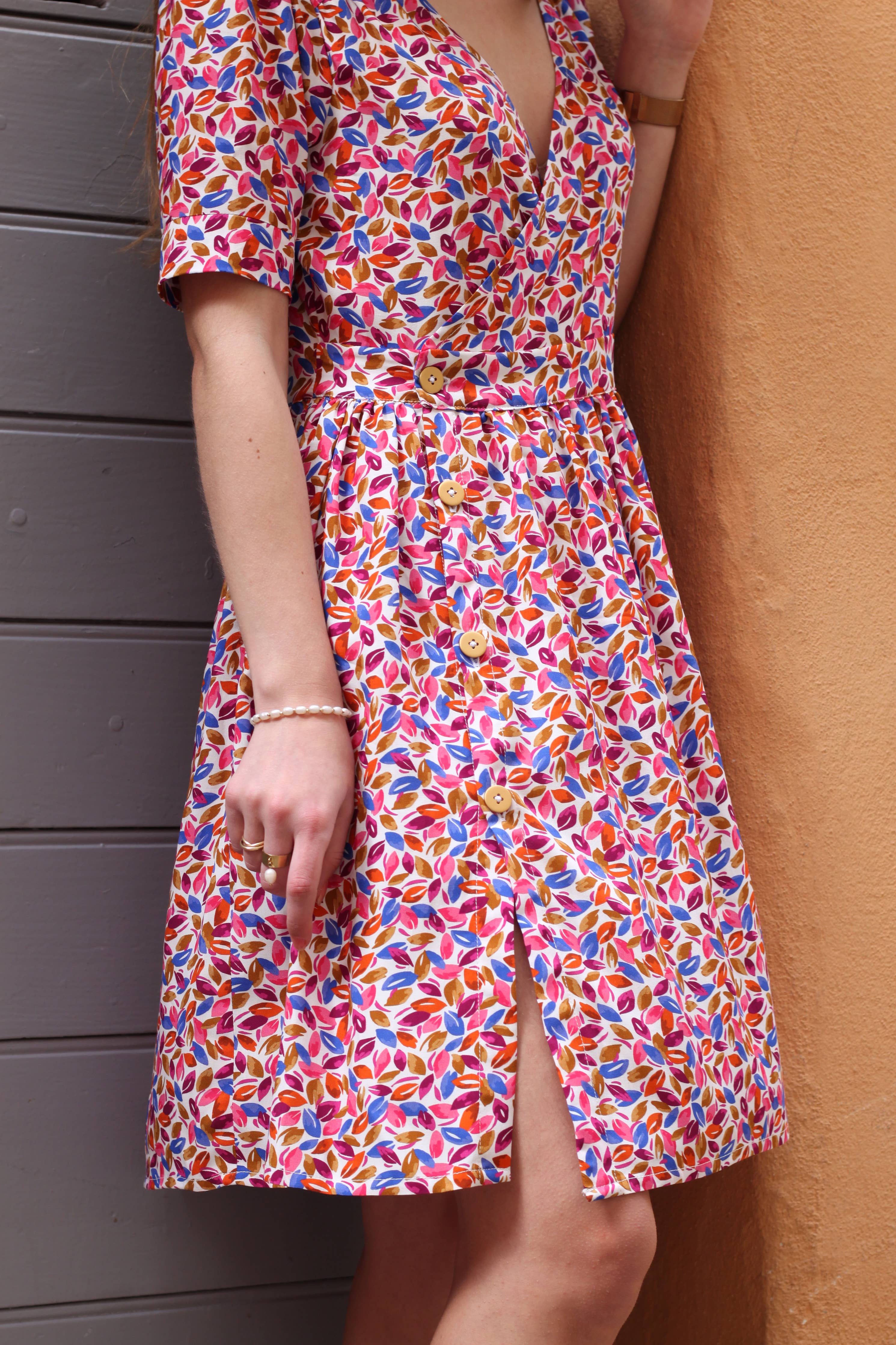 Side view of the pink floral Garance Dress showing front slit