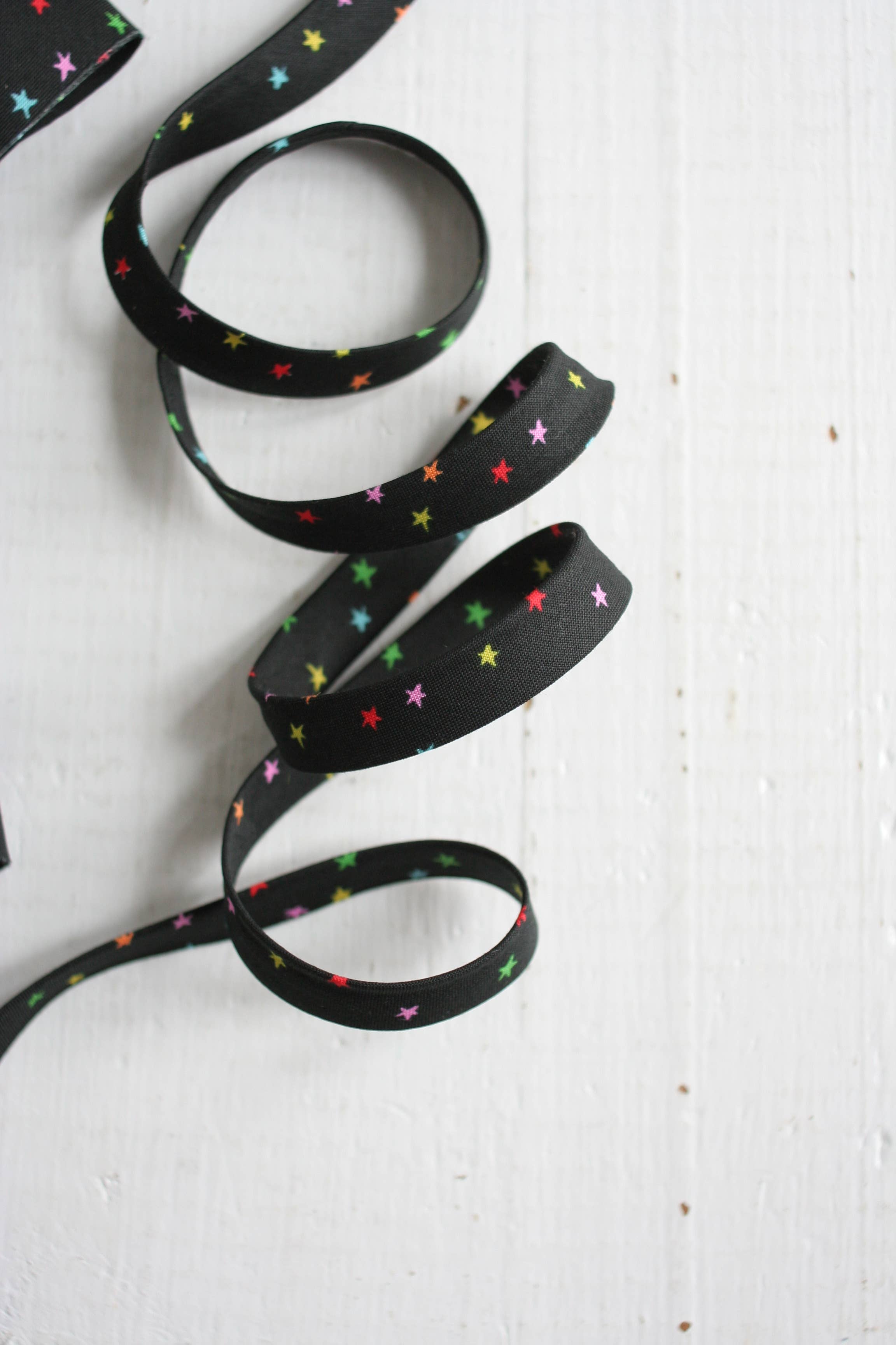 Starry Mini Vivid Rainbow 1/2 inch double fold cotton bias binding tape by Bessie Pearl Binding Co