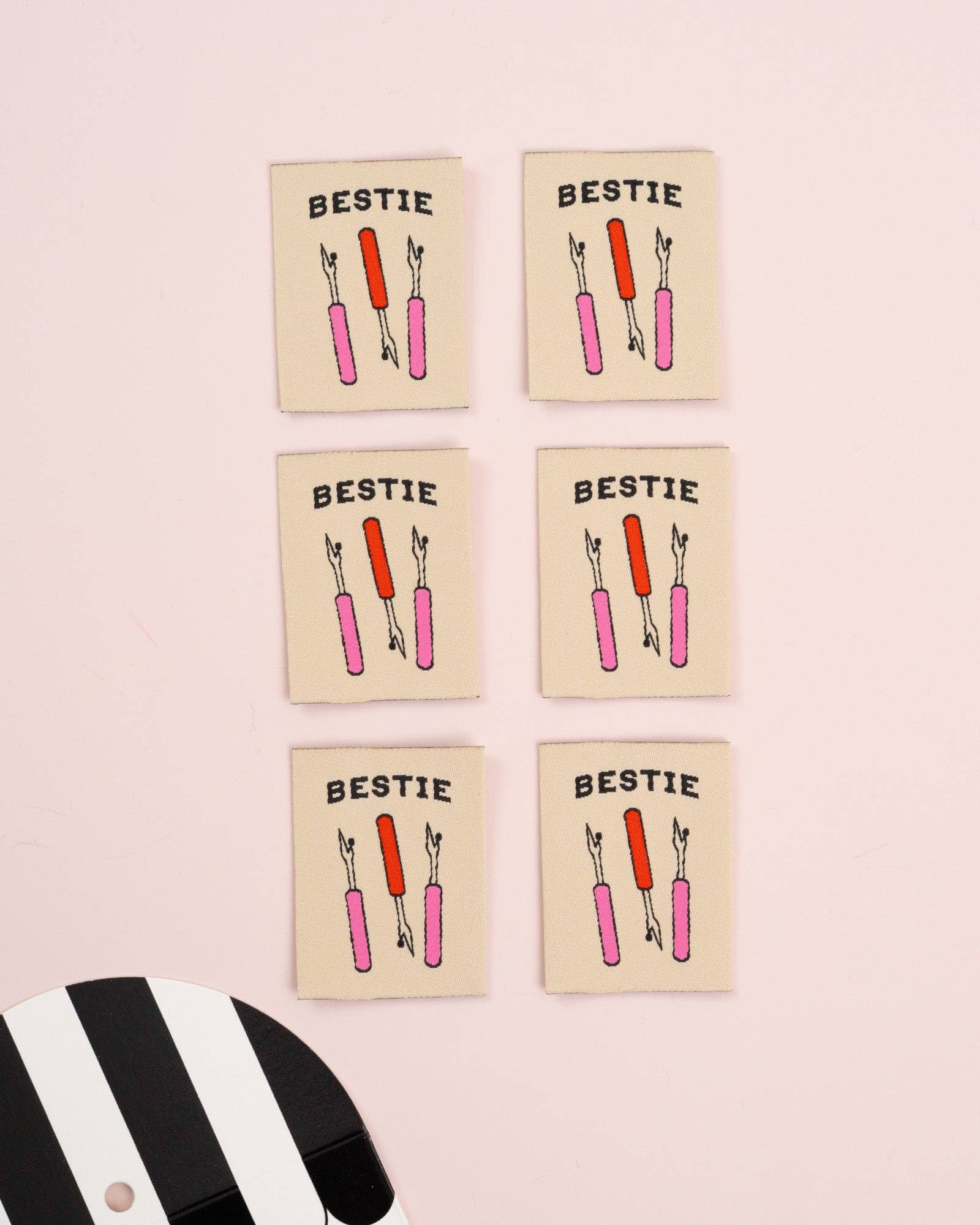 Woven garment label with Bestie Seam Ripper design, detail view