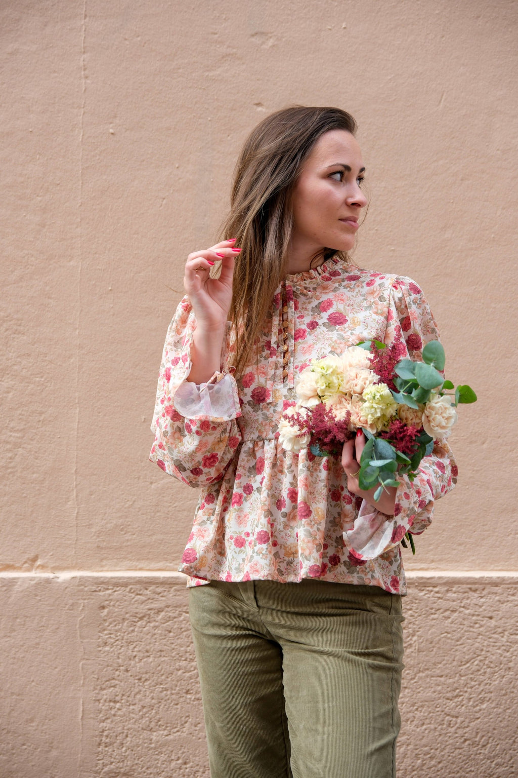 Front view of the floral Alessia Blouse showing gathered ruffle neckline, button-loop front and tie-cuff mutton sleeves