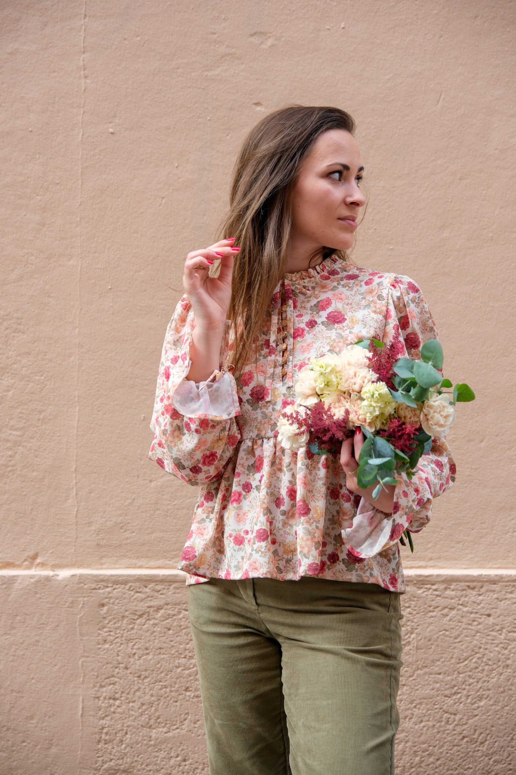Front view of the floral Alessia Blouse showing gathered ruffle neckline, button-loop front and tie-cuff mutton sleeves