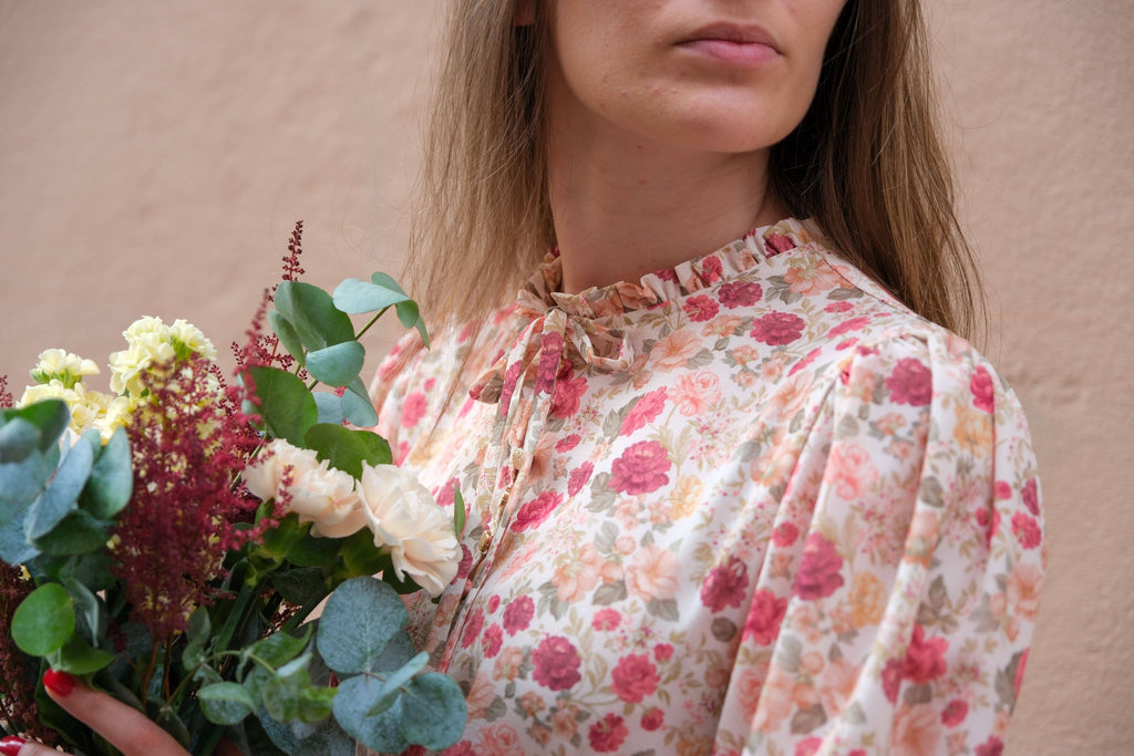 Close-up of the Alessia Blouse gathered ruffle neckline and sleeve-head gathers in rose floral fabric