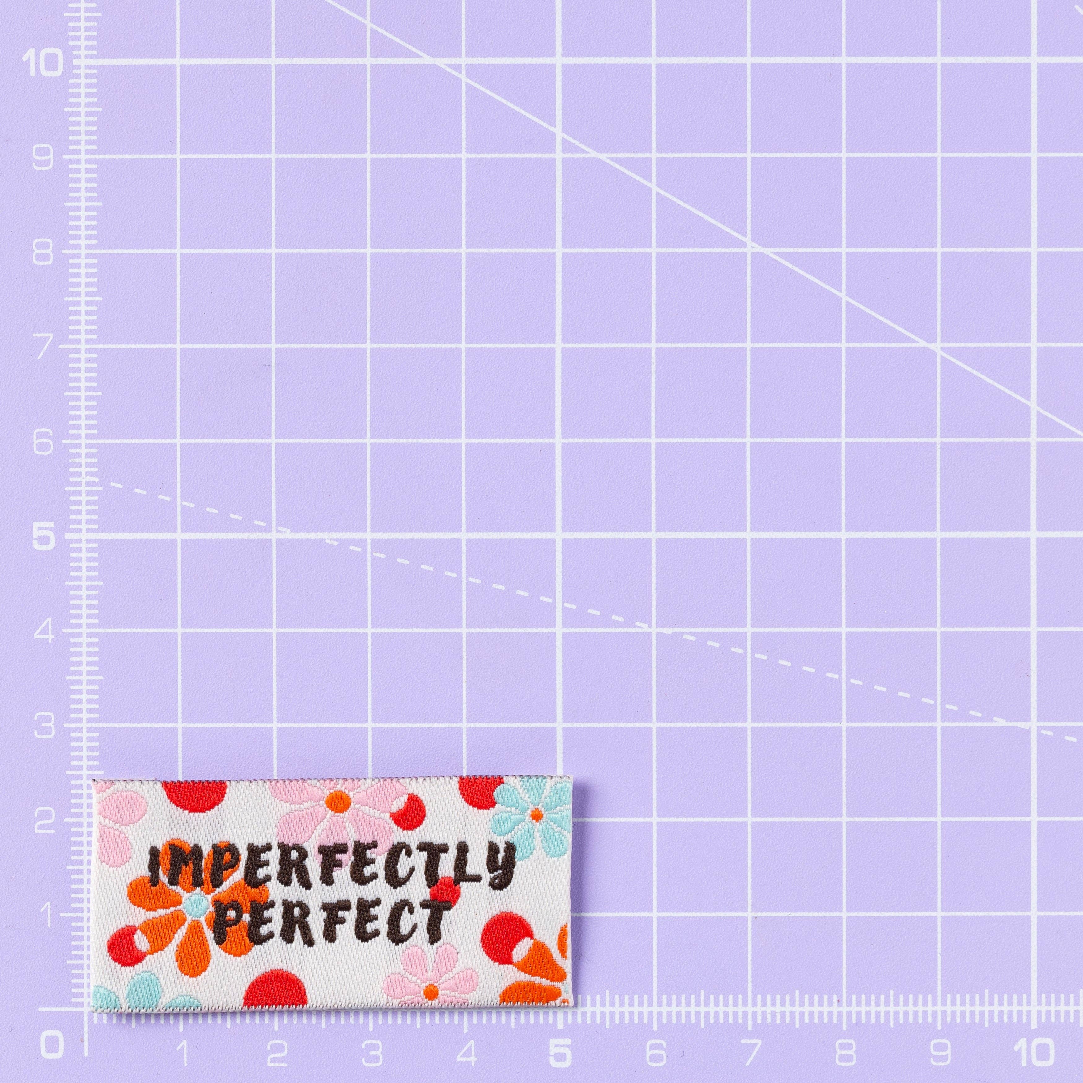Imperfectly Perfect woven labels laid out flat