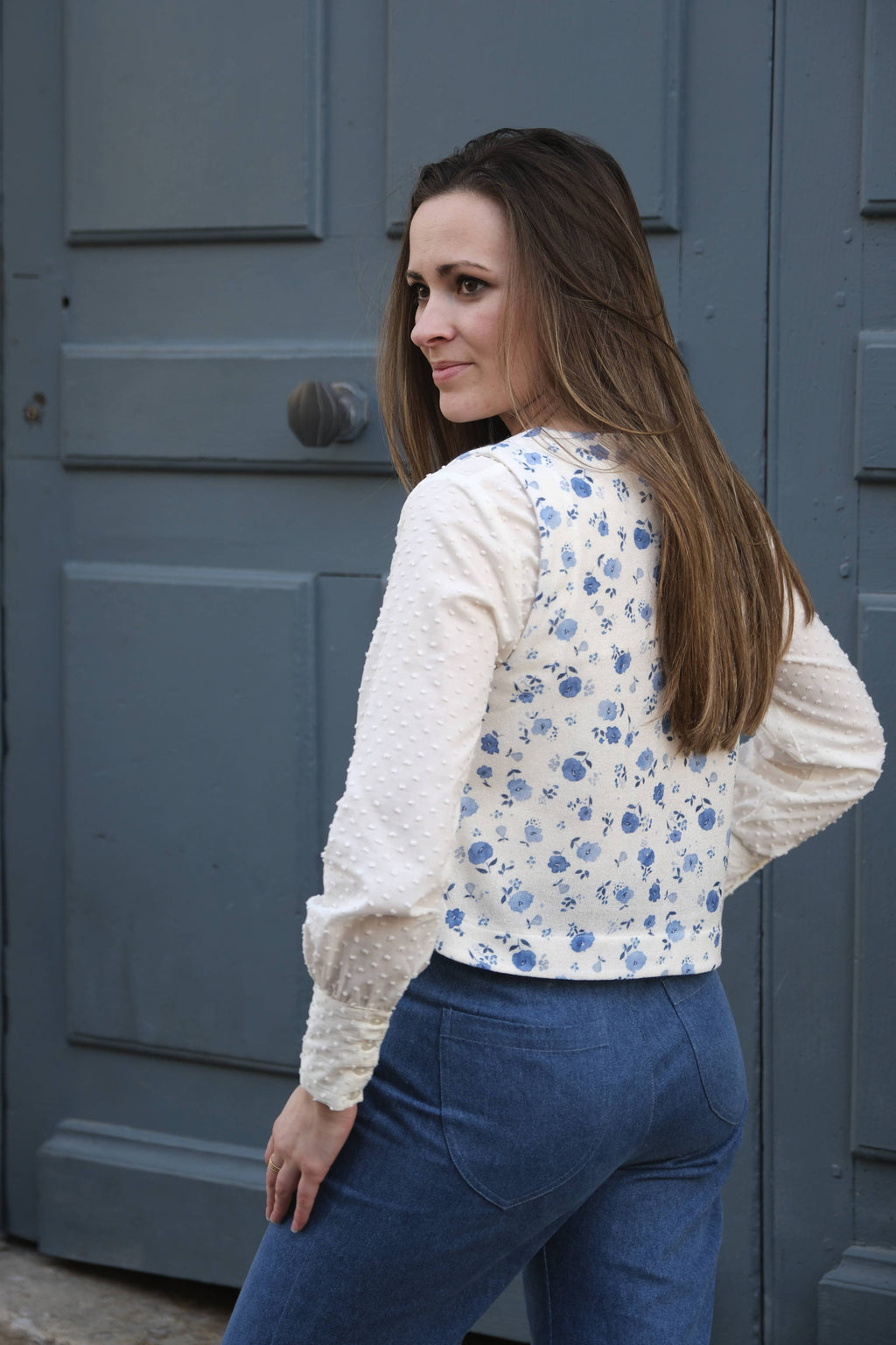 Back view of the blue floral Téva Slipover worn with jeans