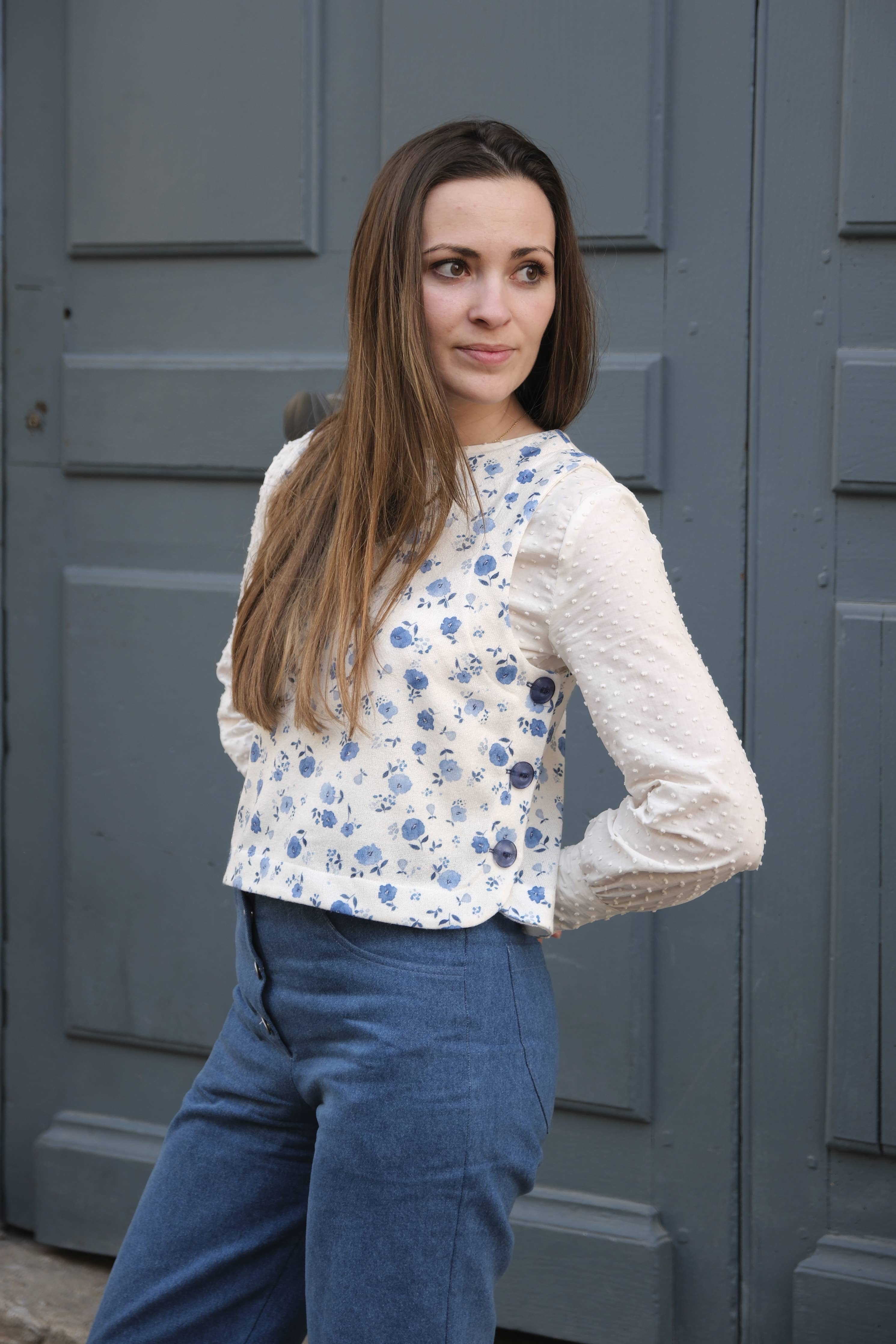 Front view of the blue floral Téva Slipover vest showing side button closure
