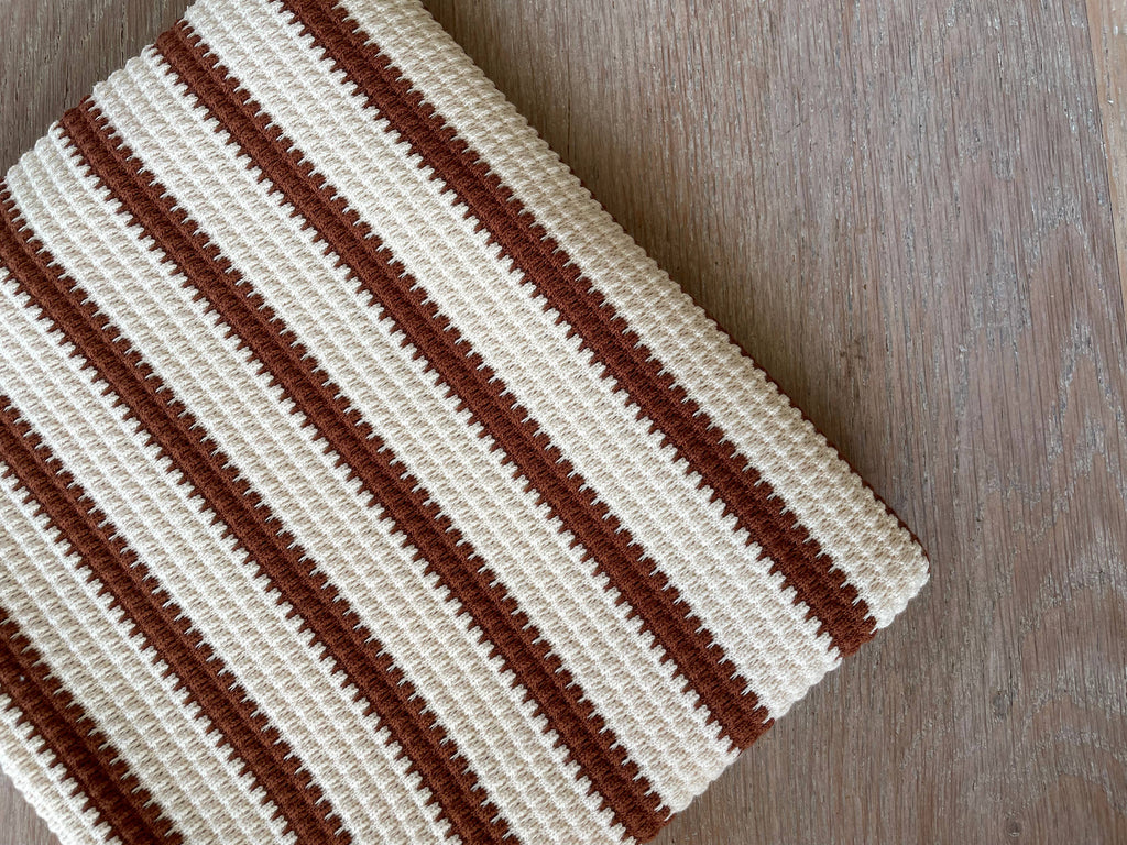 Pepita print textured knit by Atelier 27 flat lay showing ivory and mahogany stripe colorway