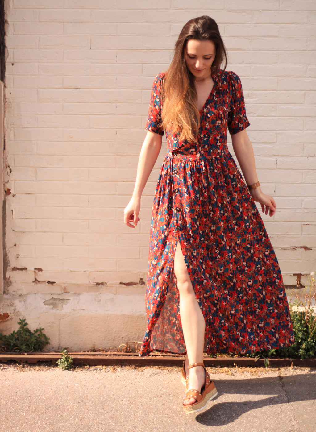 Front view of the dark floral maxi Garance Dress showing button skirt and slit
