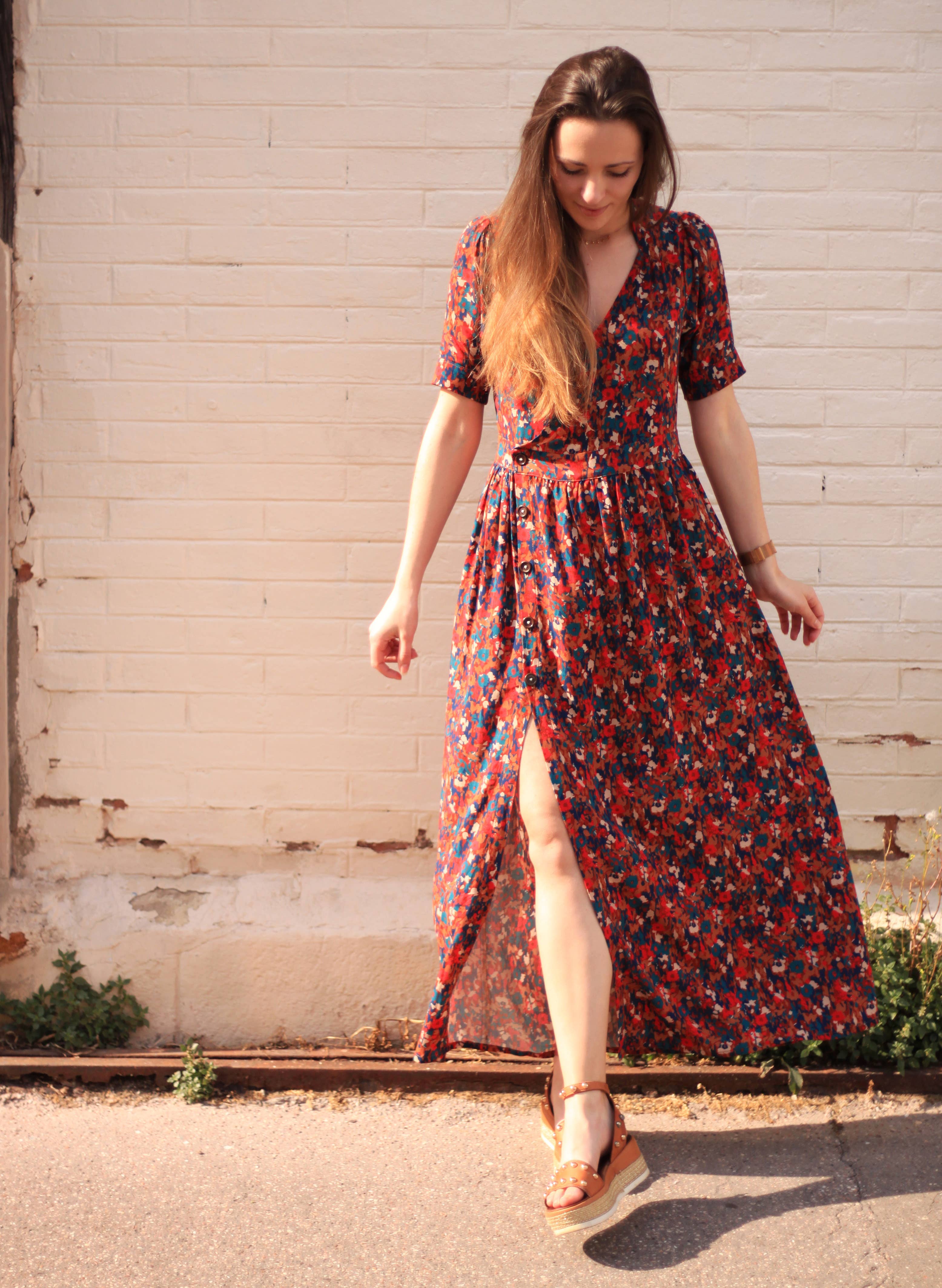 Front view of the dark floral maxi Garance Dress showing button skirt and slit