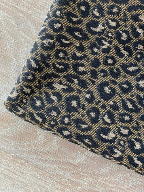 Amelia jacquard fabric folded flat, showing the woven brown and black leopard repeat across the full width | Atelier 27