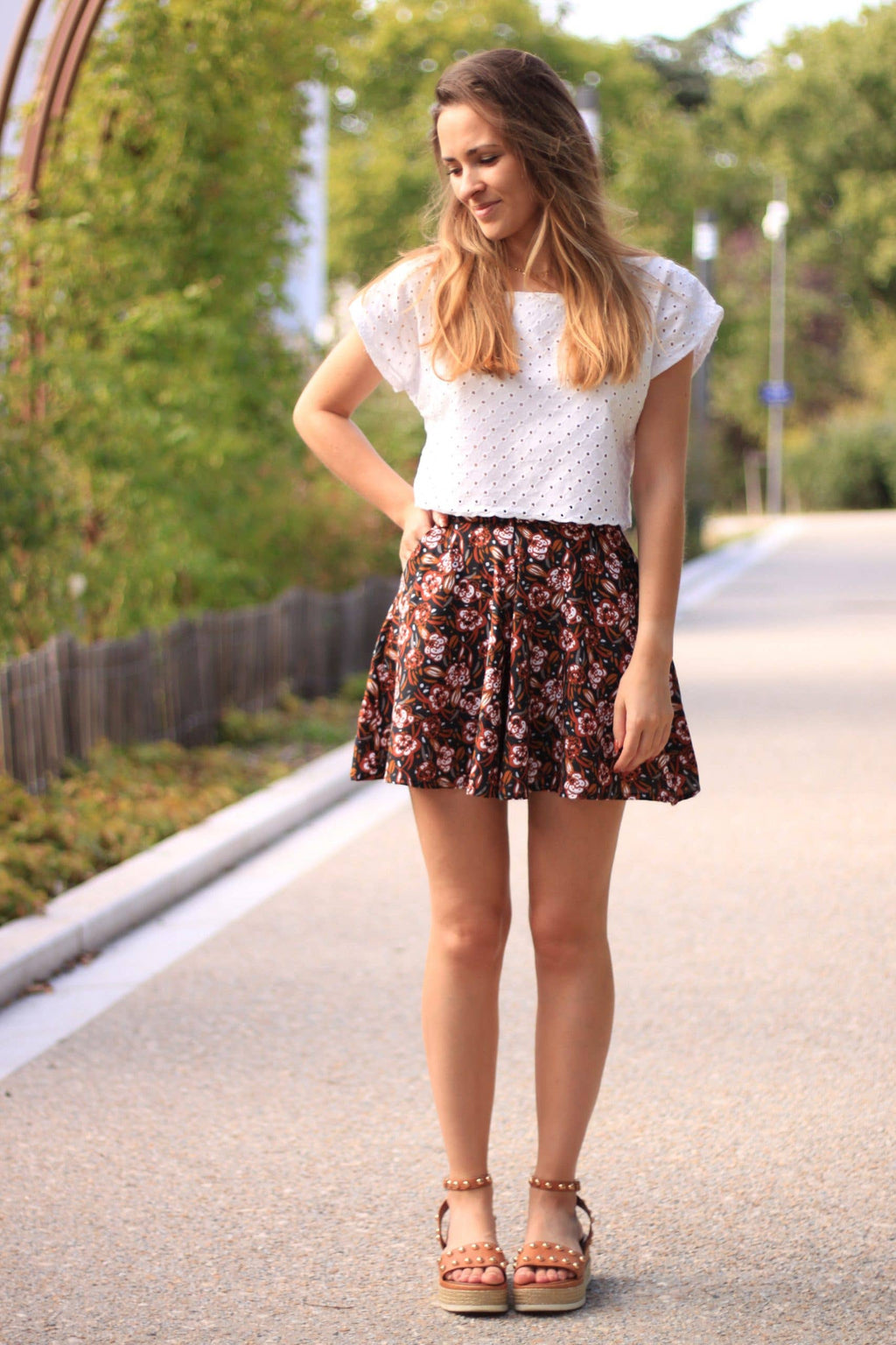 Front view of the floral Sybil skirt-look shorts with sandals