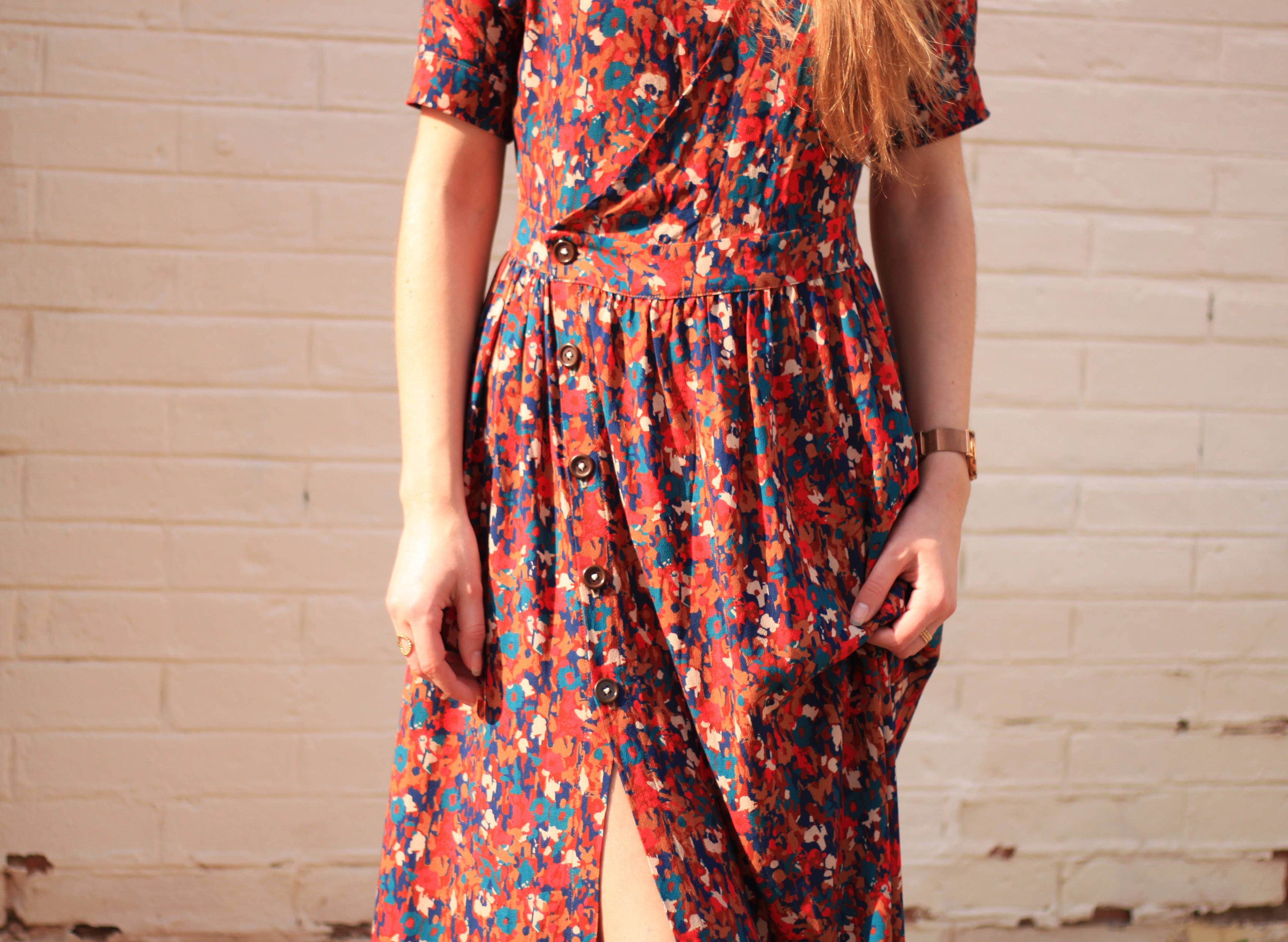 Detail of the Garance maxi Dress waist and button skirt in dark floral fabric