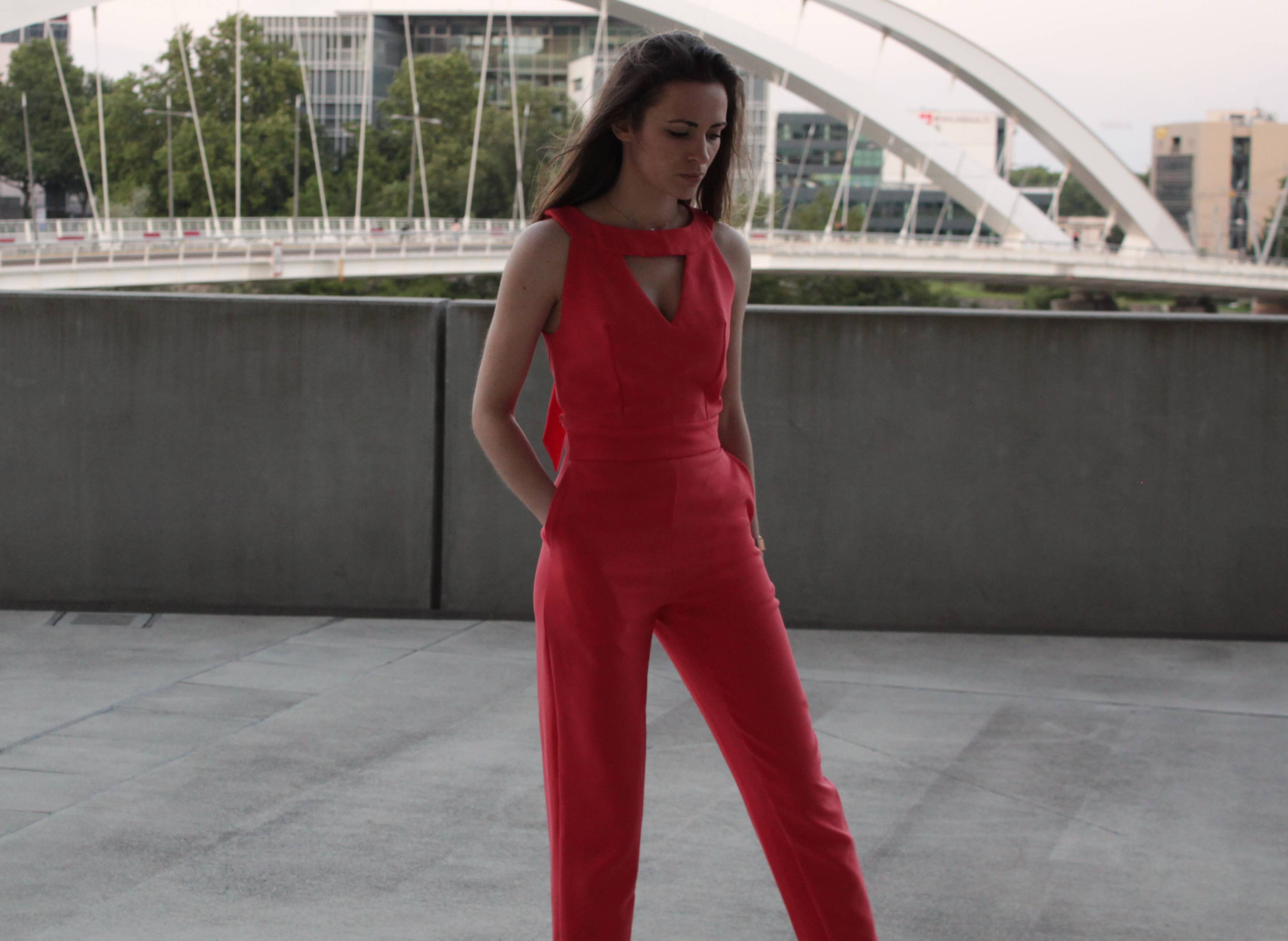 Full-length view of the red Aurore Jumpsuit showing straight-cut trousers