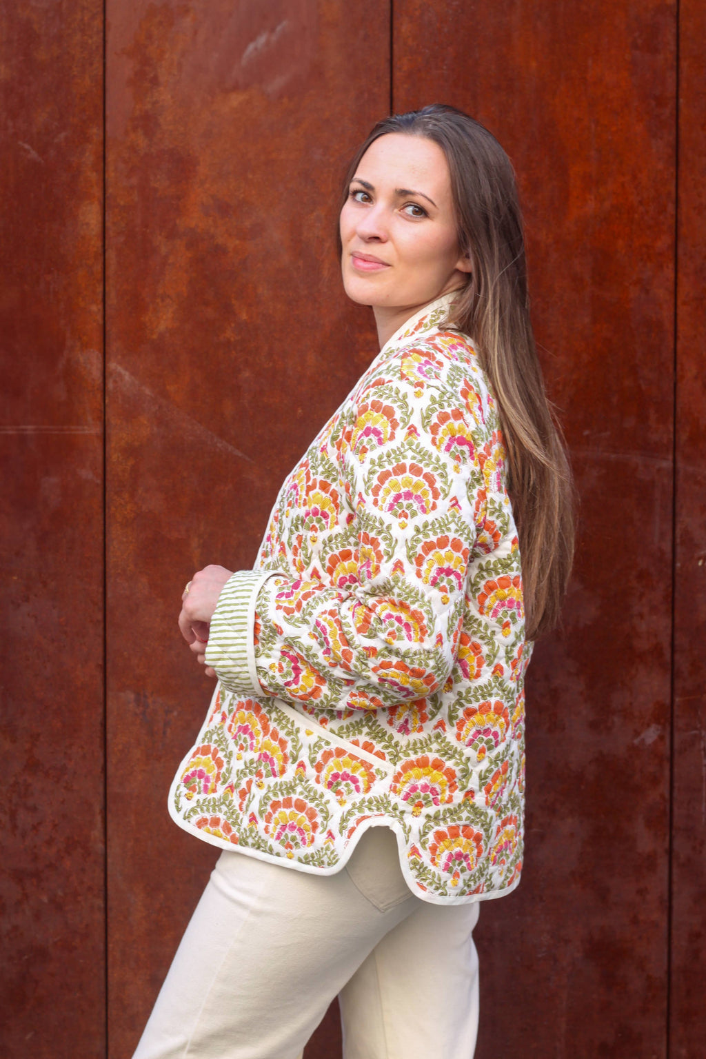 Siloé Jacket held open showing the reversible green quilted lining