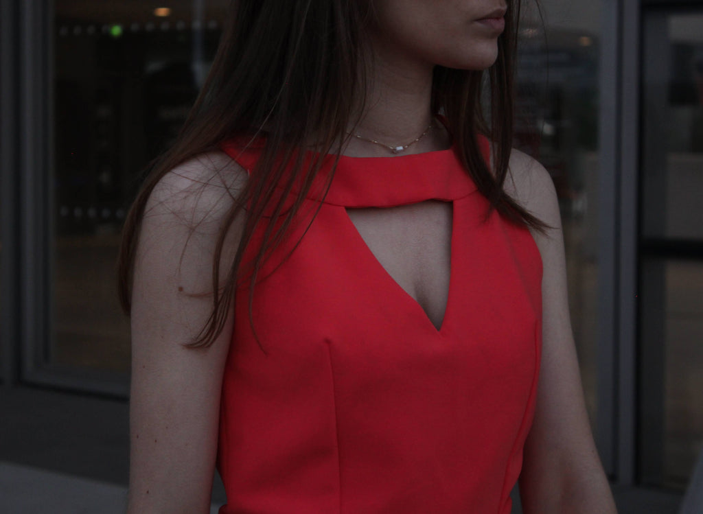 Close-up of the Aurore Jumpsuit keyhole neckline in red fabric