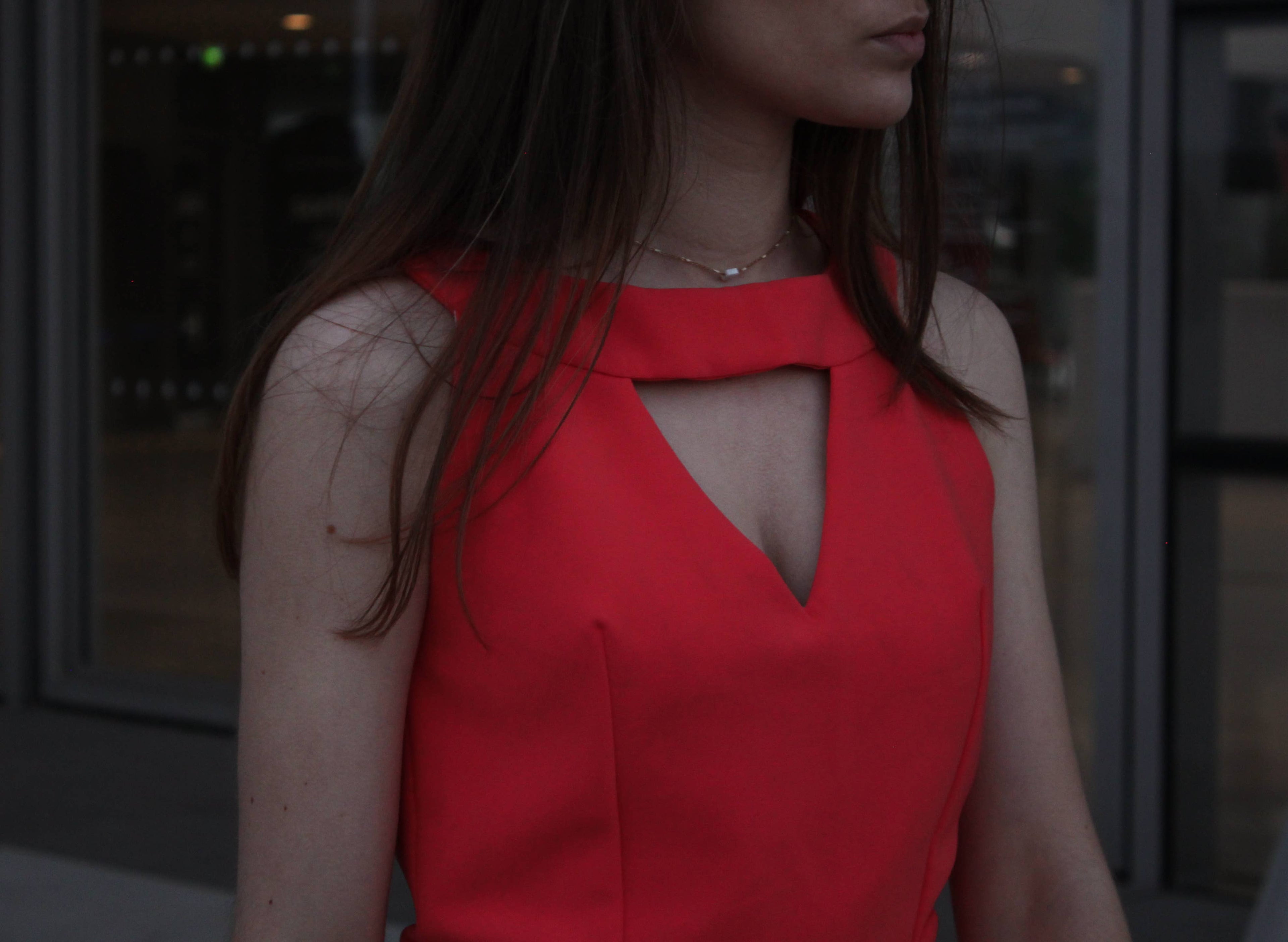 Close-up of the Aurore Jumpsuit keyhole neckline in red fabric
