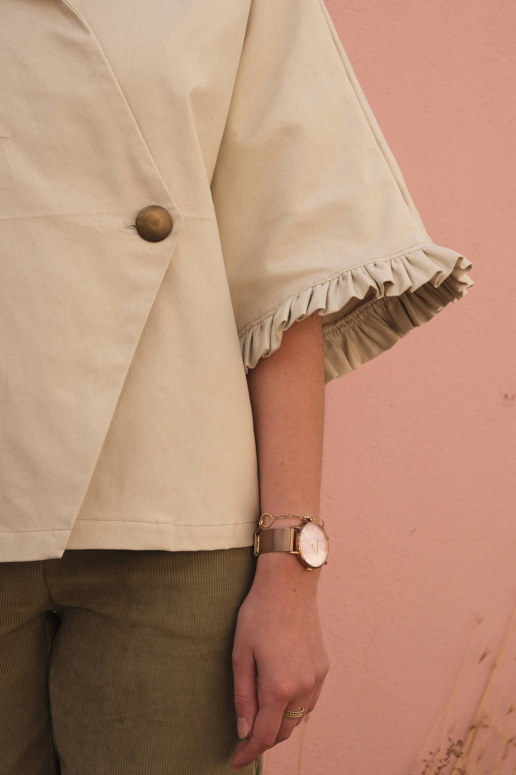 Detail of the Alixia Trench Coat ruffle-trimmed sleeve in cream fabric